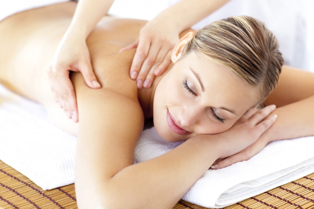 Relaxed smiling woman receiving a back massage
